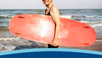 Mature woman with a surfboard and exercising